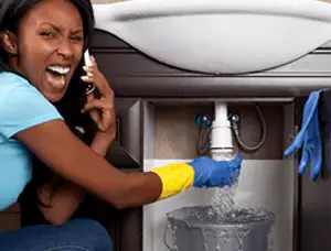 Emergency plumbing repair for a leaking sink drain under a bathroom vanity in Tulsa, OK